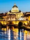 St Peters Basilica in Vatican and Ponte Sant`Angelo Bridge over Tiber River at dusk. Romantic evening cityscape of Rome Royalty Free Stock Photo