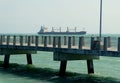 A large cargo ship passing through the pier near Fort Desoto Park, St Petersburg, Florida, U.S Royalty Free Stock Photo