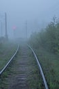 St. Petersburg, Peterhof at dawn in the summer in the fog. Thick white fog. The railway is in a fog. A thoughtful, heartfelt, extr