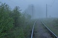 St. Petersburg, Peterhof at dawn in the summer in the fog. Thick white fog. The railway is in a fog. A thoughtful, heartfelt, extr