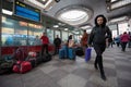 In the interior of the waiting room of the Moscow station, bags, suitcases, hand luggage. In the foreground is a young woman