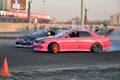 Pink racing car competing on the track T800 with a car near the Royalty Free Stock Photo