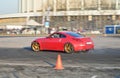 Red racing car team racing on the track near the CCM at the World Car show