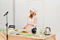 Girl chef tells how to prepare herbal tea at the presentation at