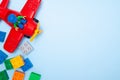 St.Petersburg, Russia- 06.03.19 - Baby kids toy frame. Top view conposition multicolor lego cubes bricks and plane on blue