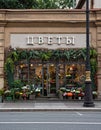 St. Petersburg, Russia - June 5, 2019, a beautiful facade of a flower shop with a bright sign and a window decorated with plants a