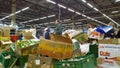 Bankruptcy and liquidation of supermarket. Retail industry. Huge pile of cardboard boxes with food on dirty floor in store. Messy