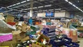 Bankruptcy and liquidation of supermarket. Retail industry. Huge pile of cardboard boxes with food on dirty floor in store. Messy.