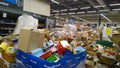 Bankruptcy of supermarket. Clutter, trash and scattered goods on dirty floor in the store. Mess, huge piles of cardboard boxes.