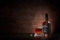 St.Petersburg, Russia - December 2019 - Bottle of Jack Daniel`s whiskey and glass with drink and ice on brown background