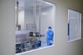 Pharmaceutical factory, pure insulated plant for the production of drugs in ampoules. Lab technician controls the manufacturing