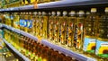 Supermarket Shelves with bottles of sunflower oil for sale. Fresh natural food products. Price. Retail place. Grocery store.