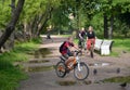 ST. PETERSBURG, RUSSIA. The family by bicycles goes on a path of park. Focus on the woman