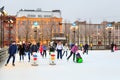 St. Petersburg, Russia -February 11, 2017: Ice skating rink in the city at winter. People learning to skate. Men and women.