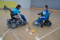 Young female sportswomen in wheelchairs prepare for competitions in the gym