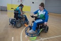 Young female sportswomen in wheelchairs prepare for competitions in the gym