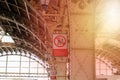 Interior of the Vitebsk railway station, sunflare. Red vertical Warning sign, translation: Do not leap from platform