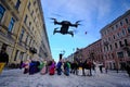 Drone flies low in the center of the city and leads photo and video filming at a city festival. Black color