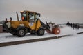 Tractor removes snow from the sidewalk