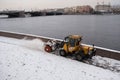 Tractor removes snow from the sidewalk