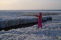 Tourists stroll along the coast of the Gulf of Finland. Sunny, fine day after a hurricane and an ice storm