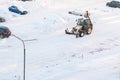 St. Petersburg, Russia - January 31, 2019: Tractor removes snow in the parking lot after a snowfall