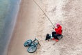 St. Petersburg, Russia - July 10, 2018: fisherman are fishing on the sandy shores of the Gulf of Finland under the bridge