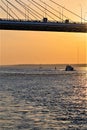 St. Petersburg, Russia, July 2018. A fragment of the cable-stayed bridge and a boat on the river against the sunset.