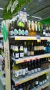 Shelves with glass bottles with wine and champagne, alcohol in supermarket. Vertical view. Aisle. Retail industry. Grocery store. Royalty Free Stock Photo
