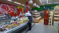 Russian Supermarket is one of largest players of retail industry in Russia. Female seller, salesperson, lays products on shelves