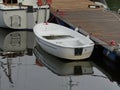 White yachts and dinghy small boat in the marina at the pier