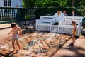 Children frolic in fountain-cracker Bench in Monplaisir garden in lower park of Peterhof