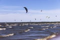 Kitesurfers on the shore of the Gulf of Finland on a windy summer day.