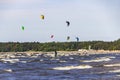 Kitesurfers on the shore of the Gulf of Finland on a windy summer day. Active sports in the vicinity of St. Petersburg