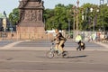 A tourist on a folding bike rides through the town square Royalty Free Stock Photo