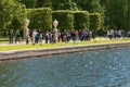 St. Petersburg, Russia - June 28, 2017: Tourists feed birds at the pond. Peterhof in St. Petersburg.