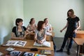 St. Petersburg, Russia - June 10, 2018: Young woman foreign language teacher in a small classroom gives students a lesson. In the Royalty Free Stock Photo