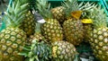 Fresh pineapple background. Exotic ananas on supermarket shelves. Farmers market. Retail industry. Grocery shopping. Healthy