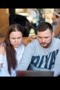 St. Petersburg, Russia-March 24, 2019. A group of four young business people gathered at the table, discussing an interesting idea Royalty Free Stock Photo