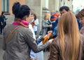 ST. PETERSBURG, RUSSIA - May 8, 2015: Distribution of St. George ribbons on the eve of Victory Day to passersby outdoor near the