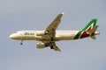 The flying plane Airbus A320 EI-DSL of Alitalia airline close up