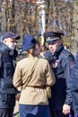 Police detain a woman in military uniform on the street of St. Petersburg