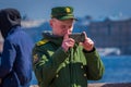 ST. PETERSBURG, RUSSIA, 01 MAY 2018: Russian man wearing military uniform with a ring in his hand, taking a picture with