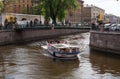 St. Petersburg, Russia - May 14, 2016: Tourist boat on the Griboyedov Canal. The ship sails under the Banking bridge.