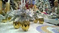 Christmas decoration stand: gold candlesticks and shiny silver decor. Traditional Xmas ornaments. Happy New Year. Winter accessori