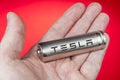 Lithium-ion battery cells to electric-vehicle, with Tesla logo.