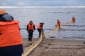 Employees of the environmental service clean up after low tide on the coast Gulf of Finland remove garbage, oil spills, harmful