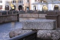 The granite embankment of the Griboyedov Canal in St. Petersburg on a wet cloudy autumn day