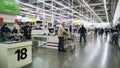 Largest hypermarket. Retail industry. Row of cash register in the store. Customers. Lighting in the supermarket. Economic