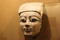 An ancient wooden pharaoh face. A fragment from a sarcophagus.